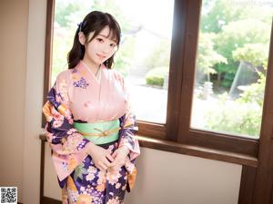 A woman in a kimono sitting on a wooden floor.