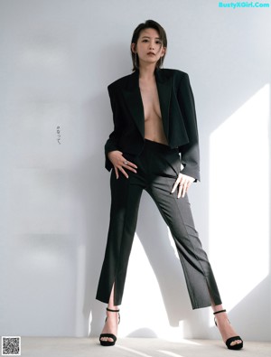 A naked asian woman is posing for a magazine cover.