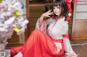 A woman in a white and red outfit posing for a picture.
