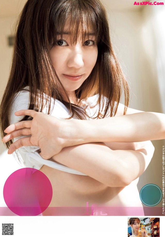 A woman in a white shirt is posing for a magazine.