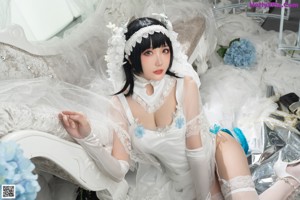 A woman in a white wedding dress posing for a picture.