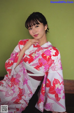 A close up of a woman laying on a bed of flowers.
