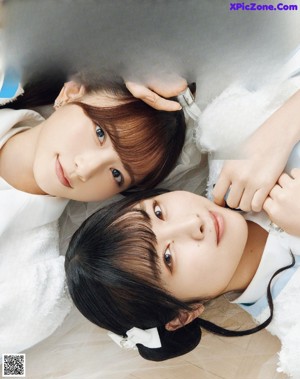 A couple of young women standing next to each other.