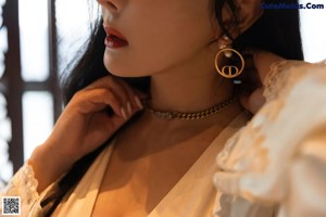 A woman standing in front of a mirror in a bathroom.