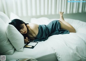 A woman in a blue bodysuit posing for a picture.