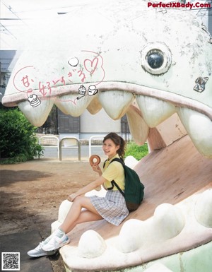 A woman holding a donut in front of her mouth.