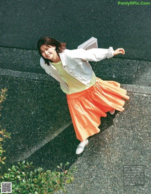 A woman in a blue coat is featured in a magazine.