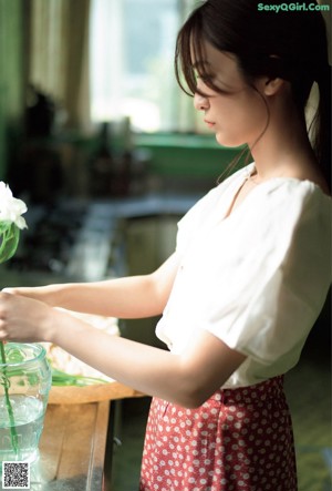 A woman wearing a bunny ears headband sitting at a table.