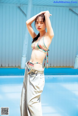 A woman in a swimming pool laughing and smiling.