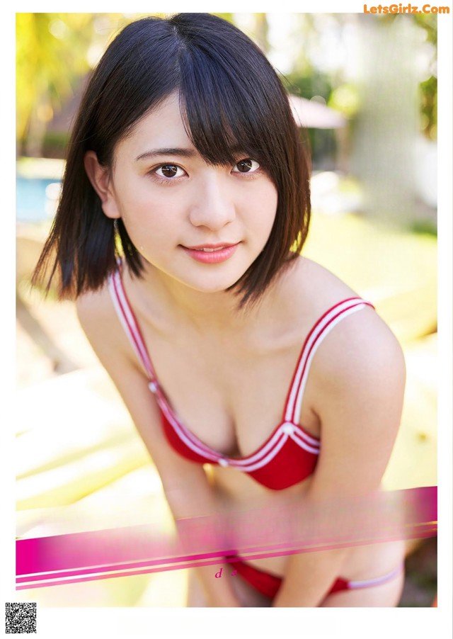 A woman in a red and white bikini posing for a picture.