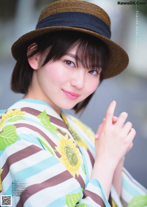 A woman in a red kimono is posing for a picture.